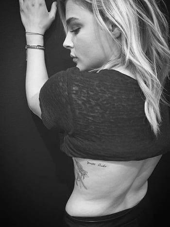 Chloë Grace MoretzSchauspielerin, Model und Freundin von Brooklyn Beckham, Chloë Grace Moretz ist ein vielbeschäftigtes Mädchen, aber sie hat sich vor kurzem die Zeit genommen, ihr eigenes Miniatur-Tattoo von JonBoy zu bekommen – ein süßes Stück auf ihrem Brustkorb mit dem Namen ihrer Großmutter, „Janette Duke“.