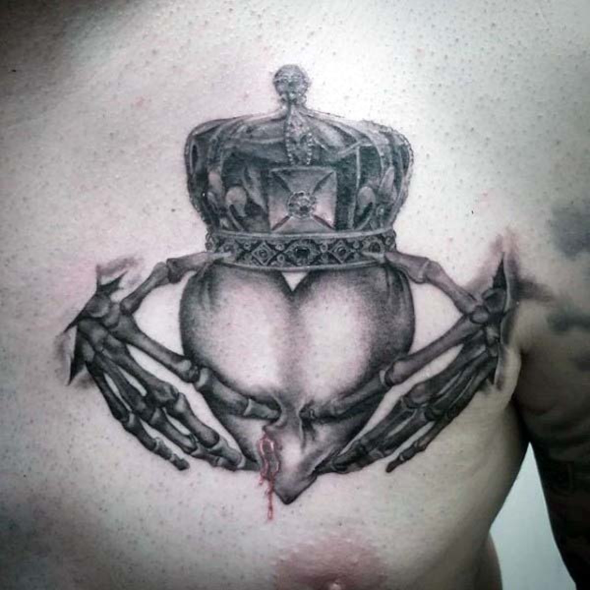 Gentleman-mit-Skelett-Händen-Claddagh-irisches-Tattoo-auf-der-oberen-Brust