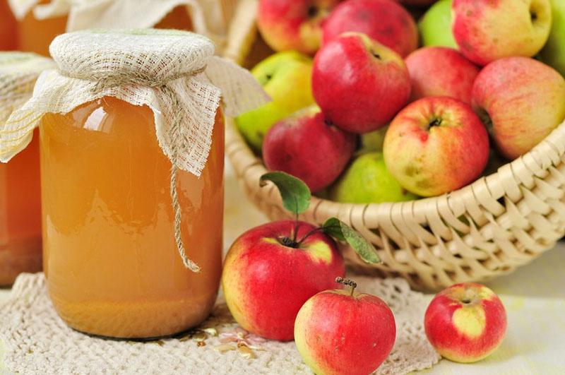 una receta tradicional de jugo de manzana para el invierno a través de un exprimidor