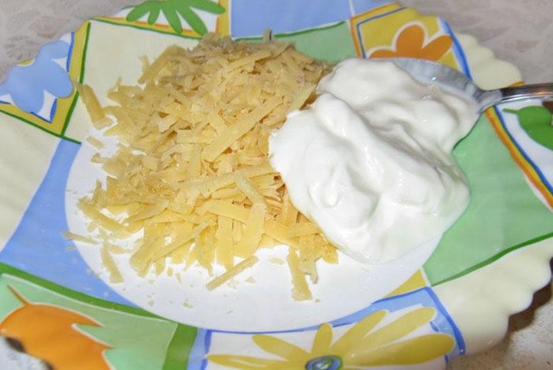 rallar el queso y mezclar con la crema agria